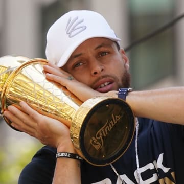Jun 20, 2022; San Francisco, CA, USA; Golden State Warriors guard Stephen Curry poses with the NBA Finals Most Valuable Player Award trophy during the Warriors championship parade in downtown San Francisco. Mandatory Credit: Cary Edmondson-USA TODAY Sports
