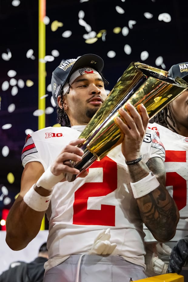 Ohio State Buckeyes wide receiver Emeka Egbuka celebrates with the trophy after defeating the Notre Dame Fighting Irish