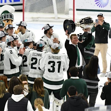 MSU hockey coach Adam Nightingale holds up Big 10 Championshjip trophy after MSU beat Ohio State in double overtime Saturday, March 22, 2025 at Munn Ice Arena.