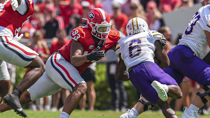 Sep 7, 2024; Athens, Georgia, USA; Georgia Bulldogs defensive lineman Tyrion Ingram-Dawkins (93) tackles Tennessee Tech Golden Eagles wide receiver D'Arious Reed (6) during the first half at Sanford Stadium. Mandatory Credit: Dale Zanine-Imagn Images