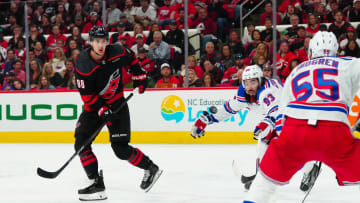 May 9, 2024; Raleigh, North Carolina, USA; Carolina Hurricanes center Martin Necas (88) shoots the puck towards the net past New York Rangers center Mika Zibanejad (93) during the third period in game three of the second round of the 2024 Stanley Cup Playoffs at PNC Arena. Mandatory Credit: James Guillory-USA TODAY Sports