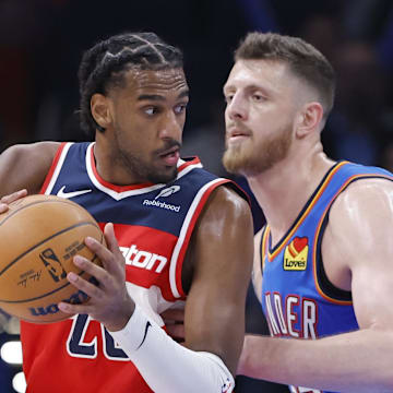 Oct 30, 2025; Oklahoma City, Oklahoma, USA; Washington Wizards center Alex Sarr (20) moves the ball as Oklahoma City Thunder center Isaiah Hartenstein (55) defends during the second half at Paycom Center. Mandatory Credit: Alonzo Adams-Imagn Images
