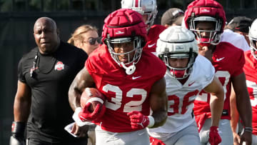 Aug 1, 2024; Columbus, OH, USA; Ohio State Buckeyes running back TreVeyon Henderson (32) runs with the ball during football camp at the Woody Hayes Athletic Complex.