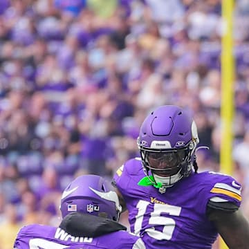 Aug 10, 2024; Minneapolis, Minnesota, USA; Minnesota Vikings linebacker Dallas Turner (15) celebrates his sack with linebacker Jihad Ward (52) against the Las Vegas Raiders in the first quarter at U.S. Bank Stadium. Mandatory Credit: Brad Rempel-Imagn Images