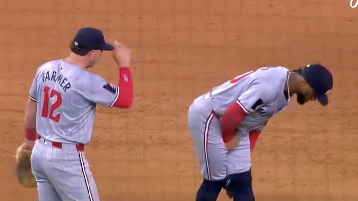 Kyle Farmer watches Willi Castro double over in discomfort.