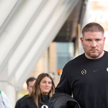 Oregon defensive coordinator Tosh Lupoi walks into the hotel as the Oregon Ducks arrive in Los Angeles ahead of the Rose Bowl Sunday, Dec. 29, 2024.