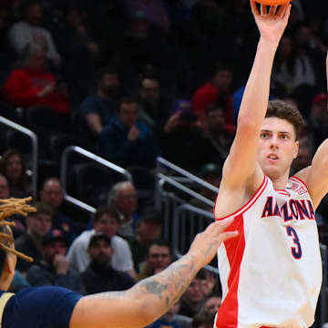 Mar 21, 2025; Seattle, WA, USA; Arizona Wildcats guard Anthony Dell'Orso (3) shoots the ball over Akron Zips guard Shammah Scott (1) during the first half in the first round of the NCAA Tournament at Climate Pledge Arena. Mandatory Credit: Steven Bisig-Imagn Images
