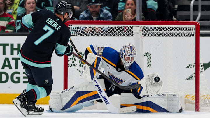 Jordan Binnington stopping a shot from Seattle F Jordan Eberle