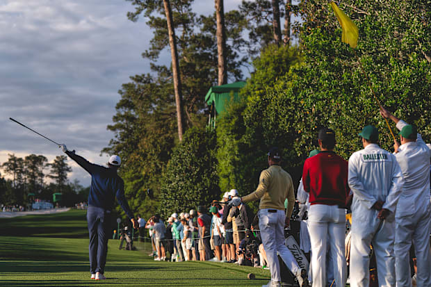 Scottie Scheffler points to his left after driving the ball into the trees on the 18th hole during the second round.