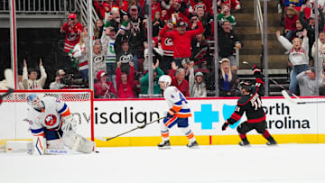 Mar 30, 2025; Raleigh, North Carolina, USA;  Carolina Hurricanes center Seth Jarvis (24) celebrates his goal past New York Islanders goaltender Marcus Hogberg (50) during the second period at Lenovo Center. Mandatory Credit: James Guillory-Imagn Images