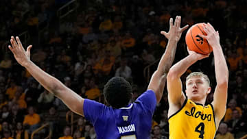 Iowa Hawkeyes guard Josh Dix (4) shoots as Washington Huskies guard Mekhi Mason (0) defends Saturday, Feb. 22, 2025 at Carver-Hawkeye Arenain Iowa City, Iowa.