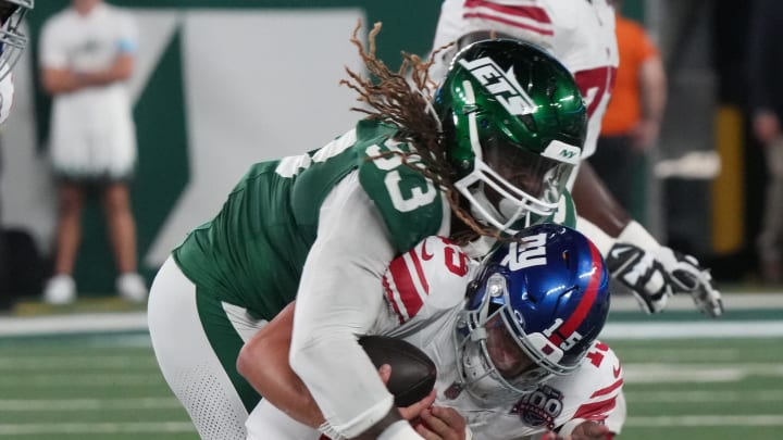 East Rutherford, NJ -- August 24, 2024 -- Tommy DeVito of the Giants is sacked by Takkarist McKinley of the Jets in the second half. The New York Giants and New York Jets meet at MetLife Stadium in the final preseason game of the 2024 season for both teams.