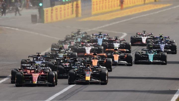 Carlos Sainz of Spain driving (55) the Ferrari SF-23 and Max Verstappen of the Netherlands driving the (1) Oracle Red Bull Racing RB19 lead the field into turn one at the start during the F1 Grand Prix of Italy at Autodromo Nazionale Monza on September 03, 2023 in Monza, Italy. 