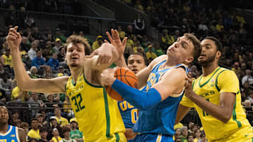 Oregon’s Nate Bittle, left, and Kwame Evans Jr., right, battle UCLA’s Tyler Bilodeau for a rebound during the second half at Matthew Knight Arena in Eugene.