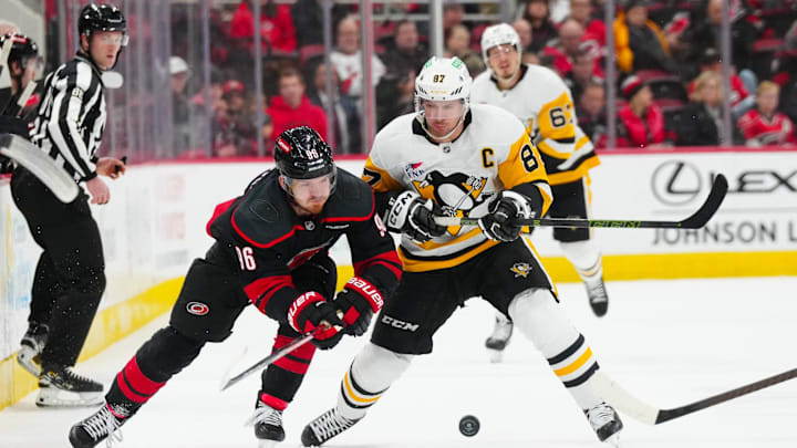 Jan 5, 2025; Raleigh, North Carolina, USA; Carolina Hurricanes center Jack Roslovic (96) and Pittsburgh Penguins center Sidney Crosby (87) battle over the puck during the third period at Lenovo Center. Jan 5, 2025; Raleigh, North Carolina, USA; Carolina Hurricanes center Jack Roslovic (96) and Pittsburgh Penguins center Sidney Crosby (87) battle over the puck during the third period at Lenovo Center.