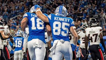 Detroit Lions wide receiver Isaac TeSlaa (18) walks off the field alongside fellow wide receiver Tom Kennedy (85)