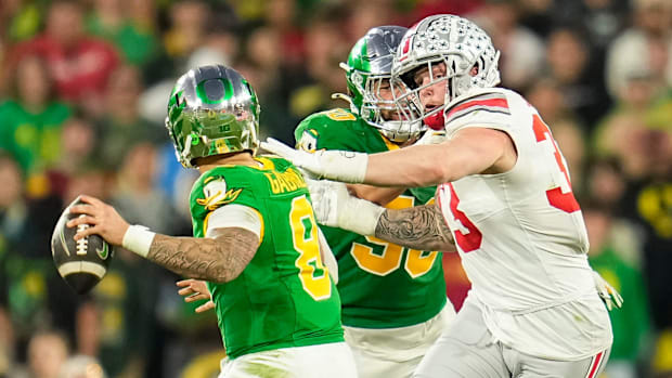 Ohio State Buckeyes defensive end Jack Sawyer (33) rushes at Oregon Ducks quarterback Dillon Gabriel (8) during the second ha