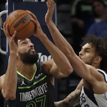 Dec 28, 2023; Minneapolis, Minnesota, USA; Minnesota Timberwolves center Rudy Gobert (27) goes to the basket against Dallas Mavericks center Dereck Lively II (2) in the second quarter at Target Center. Mandatory Credit: Bruce Kluckhohn-Imagn Images