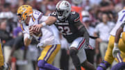 Sep 14, 2024; Columbia, South Carolina, USA; LSU Tigers quarterback Garrett Nussmeier (13) tries to avoid getting sacked by South Carolina Gamecocks linebacker Bam Martin-Scott (22) during the first quarter at Williams-Brice Stadium. Mandatory Credit: Ken Ruinard/USA TODAY Network via Imagn Images