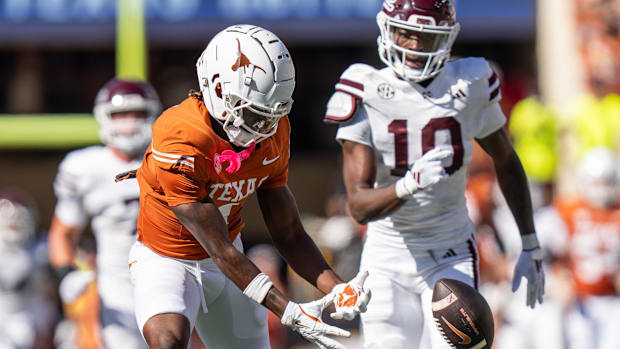 Texas Longhorns wide receiver Johntay Cook II (1) reaches out his hands as a pass slips through his reach