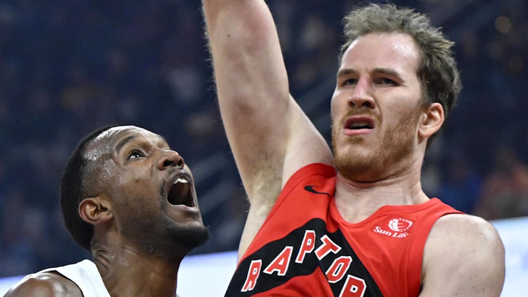 Cleveland Cavaliers center Evan Mobley drives to the basket beside Toronto Raptors center Jakob Poeltl