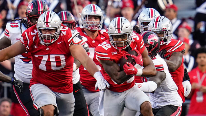 Sep 16, 2023; Columbus, Ohio, USA; Ohio State Buckeyes running back TreVeyon Henderson (32) gets a block from offensive lineman Josh Fryar (70) during the second half of the NCAA football game against the Western Kentucky Hilltoppers at Ohio Stadium. Ohio State won 63-10.