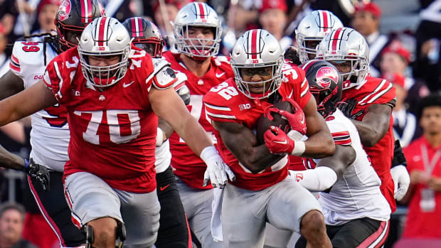 Offensive lineman runs next to running back to block.