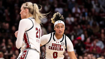 South Carolina basketball guard Te-Hina Paopao dribbling behind a screen from forward Chloe Kitts.