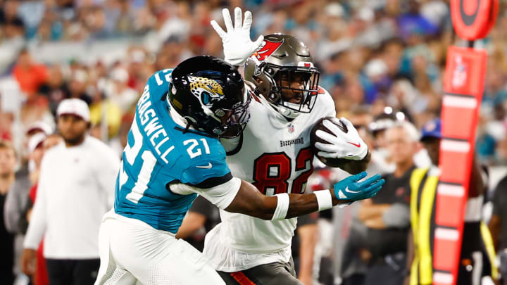 Aug 17, 2024; Jacksonville, Florida, USA; Tampa Bay Buccaneers tight end Devin Culp (82) runs with the ball as Jacksonville Jaguars cornerback Christian Braswell (21) defends during the second quarter at EverBank Stadium. Mandatory Credit: Douglas DeFelice-USA TODAY Sports