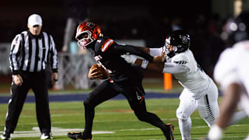 Harrisburg's Messiah Mickens sacks Central York quarterback Brooklyn Nace during the PIAA District 3 Class 6A Championship at Cedar Cliff High School on Friday, Nov. 21, 2025, in New Cumberland.