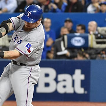 Oct 14, 2015; Toronto, Ontario, CAN; Texas Rangers left fielder Josh Hamilton hits a double against the Toronto Blue Jays in the sixth inning in game five of the ALDS at Rogers Centre. 