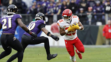 Jan 28, 2024; Baltimore, Maryland, USA; Kansas City Chiefs running back Clyde Edwards-Helaire (25) carries the ball as Baltimore Ravens cornerback Arthur Maulet (10) defends during the first half in the AFC Championship football game at M&T Bank Stadium. Mandatory Credit: Geoff Burke-Imagn Images