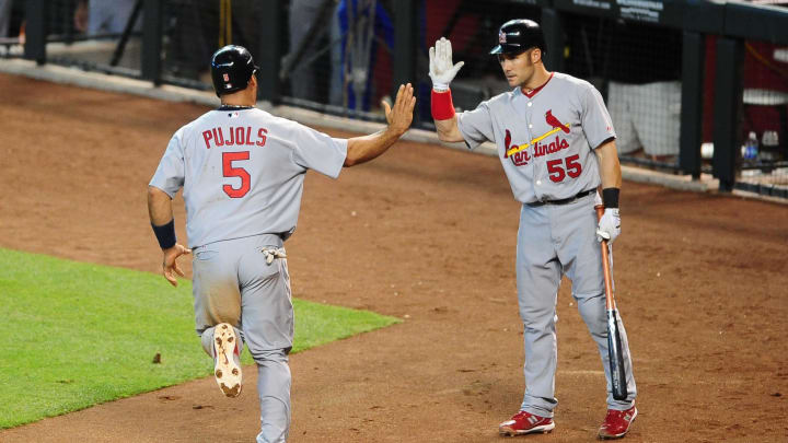 Jun. 13, 2010; Phoenix, AZ, USA; St. Louis Cardinals first baseman (5) Albert Pujols is congratulated by teammate Skip Schumaker after scoring against the Arizona Diamondbacks at Chase Field. Mandatory Credit: Mark J. Rebilas-USA TODAY Sports