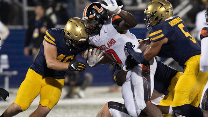 Lakeland's Malik Morris fights for a first down against St. Thomas Aquinas on Thursday night at Pitbull Stadium in the 2025 FHSAA Class 5A State Football Finals.