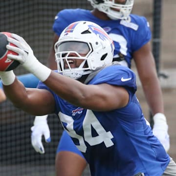 Bills edge Dawuane Smoot shoots off the line holding up a weighted ball.