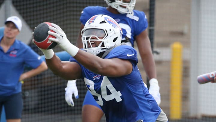 Bills edge Dawuane Smoot shoots off the line holding up a weighted ball.