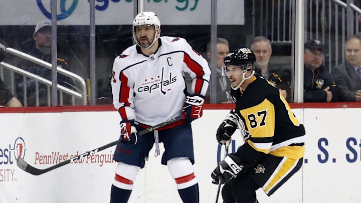 Mar 25, 2023; Pittsburgh, Pennsylvania, USA;  Washington Capitals left wing Alex Ovechkin (8) and Pittsburgh Penguins center Sidney Crosby (87) look for the puck during the third period at PPG Paints Arena. Pittsburgh won 4-3. Mandatory Credit: Charles LeClaire-Imagn Images