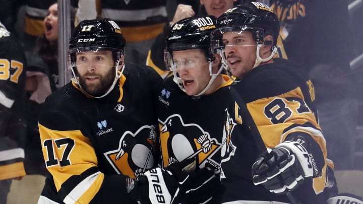 Jan 27, 2024; Pittsburgh, Pennsylvania, USA;  Pittsburgh Penguins left wing Jake Guentzel (middle) celebrates with right wing Bryan Rust (17) and center Sidney Crosby (87) after Guentzel scored a goal against the Montreal Canadiens during the third period at PPG Paints Arena. The Penguins won 3-2 in overtime. Mandatory Credit: Charles LeClaire-USA TODAY Sports