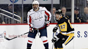 Mar 25, 2023; Pittsburgh, Pennsylvania, USA;  Washington Capitals left wing Alex Ovechkin (8) and Pittsburgh Penguins center Sidney Crosby (87) look for the puck during the third period at PPG Paints Arena. Pittsburgh won 4-3. Mandatory Credit: Charles LeClaire-Imagn Images