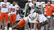 Nov 22, 2025; Blacksburg, Va.; Miami defensive back Bryce Fitzgerald (13) tackles Virginia Tech wide receiver Isaiah Spencer (11) during the fourth quarter at Lane Stadium.