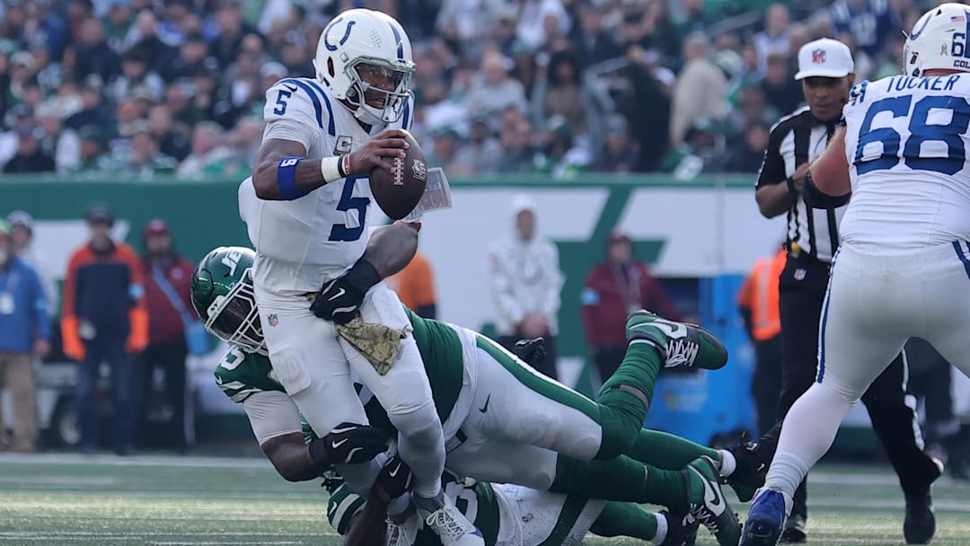 Nov 17, 2024; East Rutherford, New Jersey, USA; Indianapolis Colts quarterback Anthony Richardson (5) is sacked by New York Jets defensive tackle Quinnen Williams (95) and New York Jets linebacker Quincy Williams (56) during the second quarter at MetLife Stadium. Mandatory Credit: Brad Penner-Imagn Images