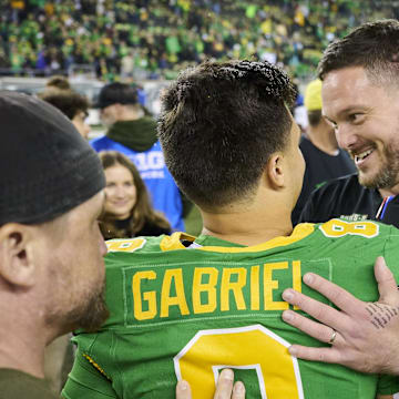 Nov 9, 2024; Eugene, Oregon, USA; Oregon Ducks head coach Dan Lanning celebrates with quarterback Dillon Gabriel (8) after beating the Maryland Terrapins at Autzen Stadium. Mandatory Credit: Troy Wayrynen-Imagn Images
