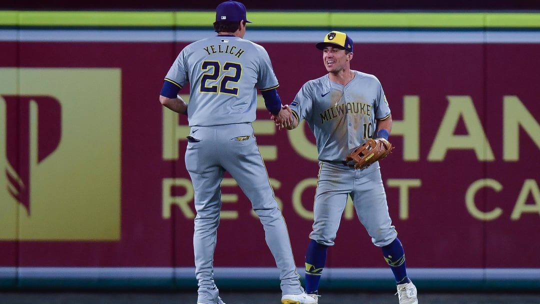 Jun 18, 2024; Anaheim, California, USA; Milwaukee Brewers outfielder Sal Frelick (10) celebrates with outfielder Christian Yelich (22) after catching the fly ball of Los Angeles Angels outfielder Taylor Ward (3) for the last out of the game at Angel Stadium. Mandatory Credit: Gary A. Vasquez-USA TODAY Sports