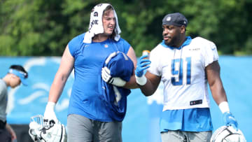 Detroit Lions offensive lineman Colby Sorsdal, left, and defensive end Levi Onwuzurike walk off the field 