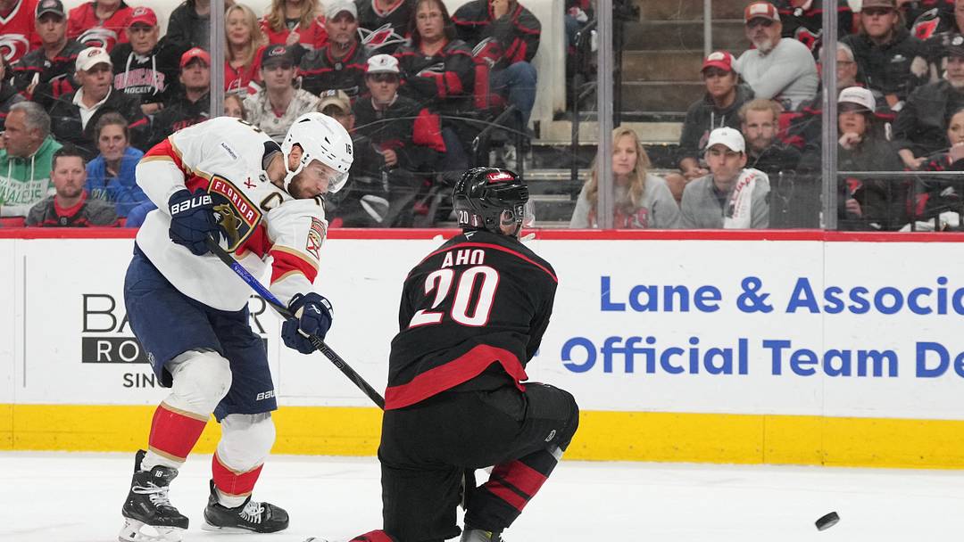 May 28, 2025; Raleigh, North Carolina, USA; Florida Panthers forward Aleksander Barkov (16) shoots the puck against Carolina Hurricanes forward Sebastian Aho (20) during the second period in game five of the Eastern Conference Final of the 2025 Stanley Cup Playoffs at Lenovo Center. Mandatory Credit: James Guillory-Imagn Images