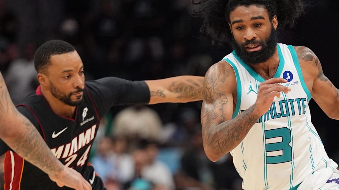 Apr 14, 2026; Charlotte, North Carolina, USA; Charlotte Hornets guard Coby White (3) goes to the basket past Miami Heat guard Norman Powell (24) during the second half during the play-in rounds between the Charlotte Hornets and the Miami Heat of the 2026 NBA Playoffs at Spectrum Center. Mandatory Credit: Jim Dedmon-Imagn Images