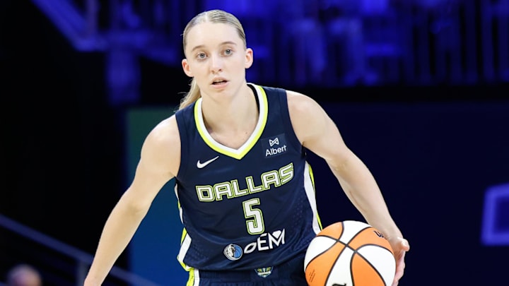 Jul 16, 2025; Arlington, Texas, USA; Dallas Wings guard Paige Bueckers (5) controls the ball against Las Vegas Aces guard Jackie Young (0) during the second half at College Park Center. Mandatory Credit: Chris Jones-Imagn Images