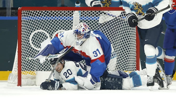 Feb 11, 2026; Milan, Italy; Sebastian Aho of Finland in action with Samuel Hlavaj of Slovakia in men's ice hockey group B play during the Milano Cortina 2026 Olympic Winter Games at Milano Santagiulia Ice Hockey Arena. Mandatory Credit: Geoff Burke-Imagn Images