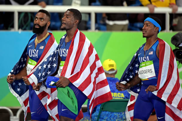 U.S. relay sprinters Tyson Gay, Justin Gatlin and Mike Rodgers look on after being disqualified at the 2016 Rio Olympics.