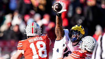 Michigan defensive lineman Rayshaun Benny (26) tries to block a pass from Ohio State quarterback Will Howard (18) during the second half at Ohio Stadium in Columbus, Ohio on Saturday, Nov. 30, 2024.